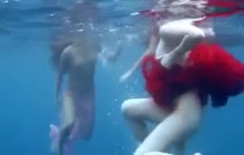 Three girls stripping in the sea